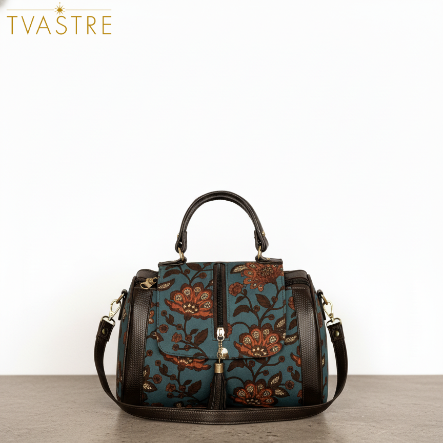 Floral patterned handbag on a wooden surface with 'Tvastre' branding.